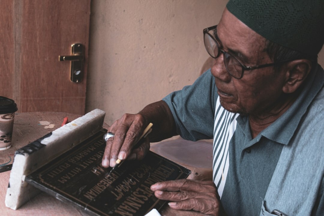 Senior citizen using a tablet with help from a volunteer